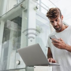 bearded-man-checking-portable-devices