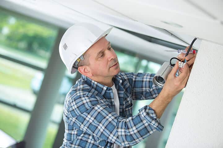 contractor installing a security camera system