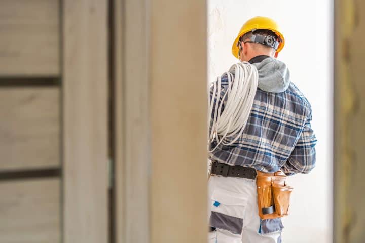 Electrical Systems Installer. Caucasian Electric Technician at Work.