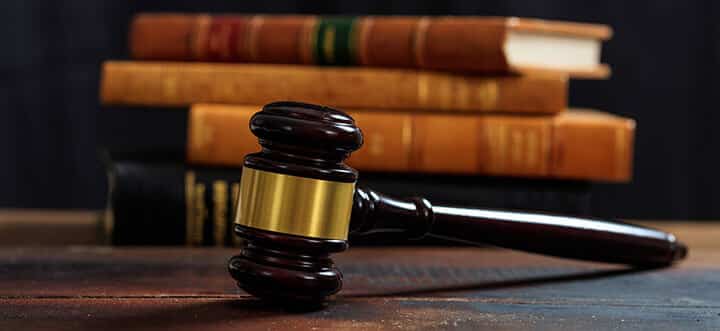 judge gavel on a wooden desk and law books