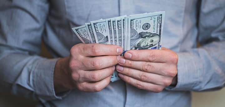 Man holding money and ready to pay for the camera installation