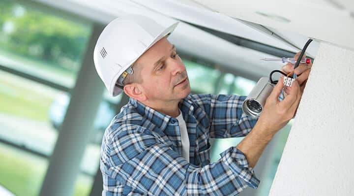 man installing a security camera system