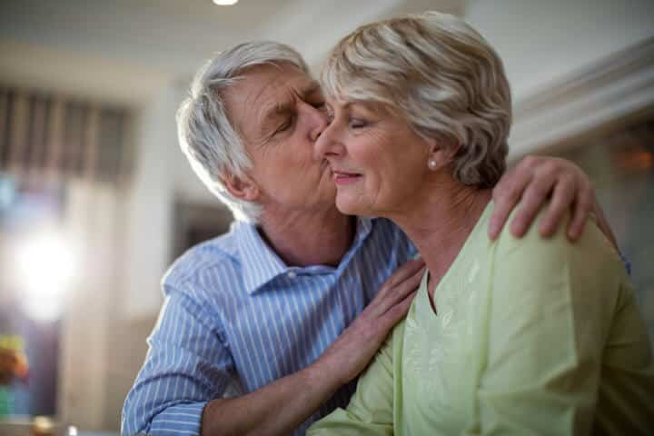 senior man kissing senior woman