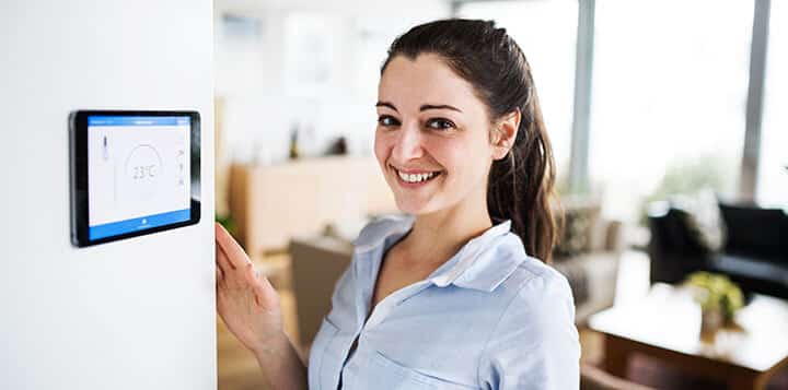 woman looking at tablet with smart home screen