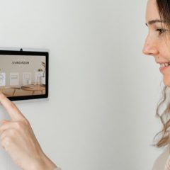 Woman pressing alarm panel buttons